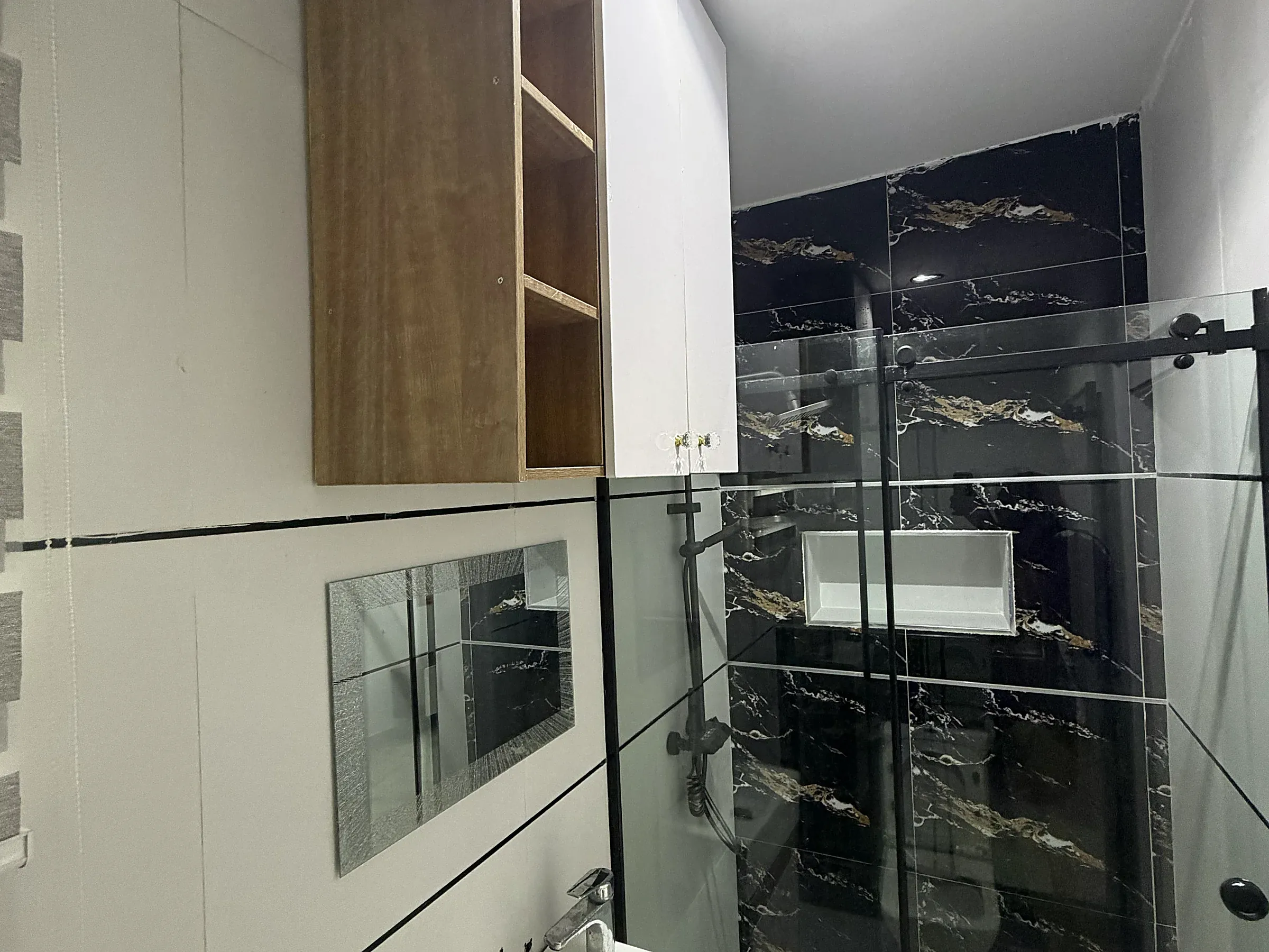 Third-bedroom en-suite with a glass shower enclosure and fitted vanity
