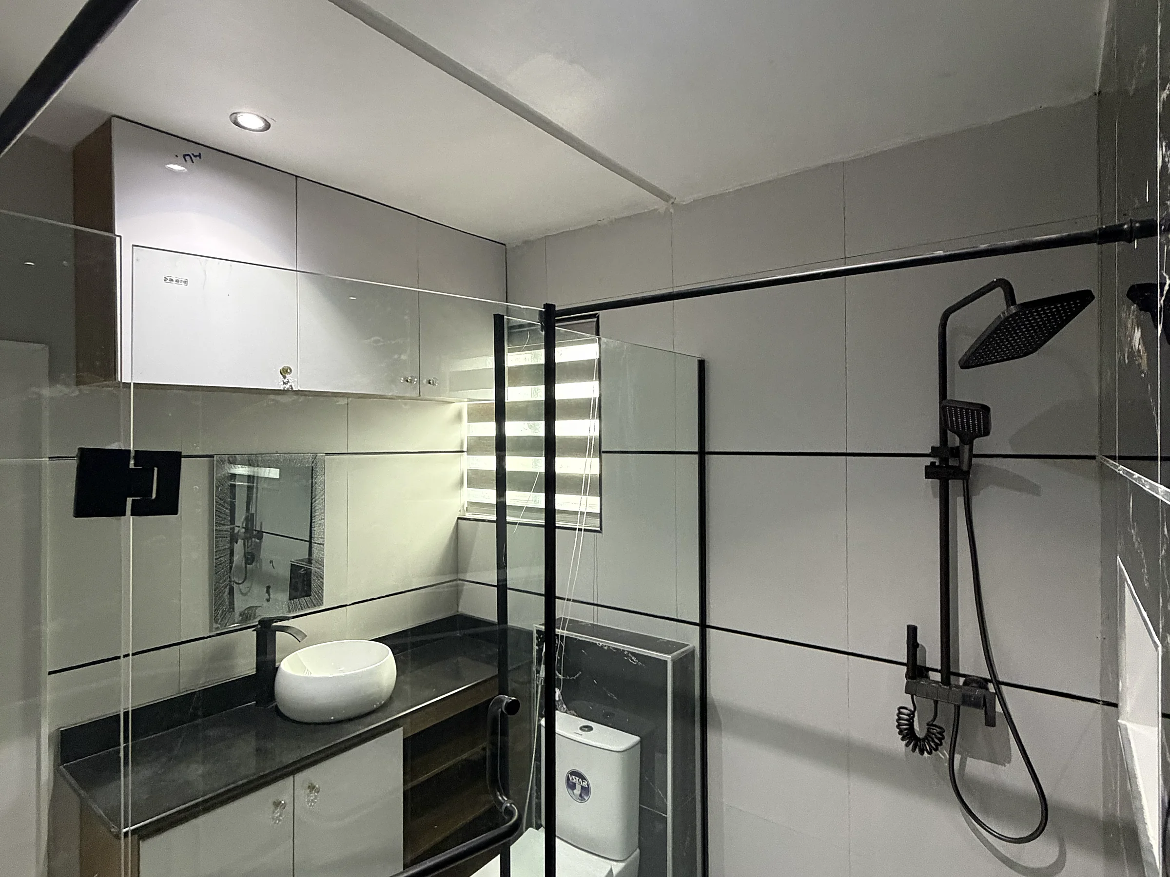 Second-bedroom en-suite with a glass shower enclosure and rainfall shower