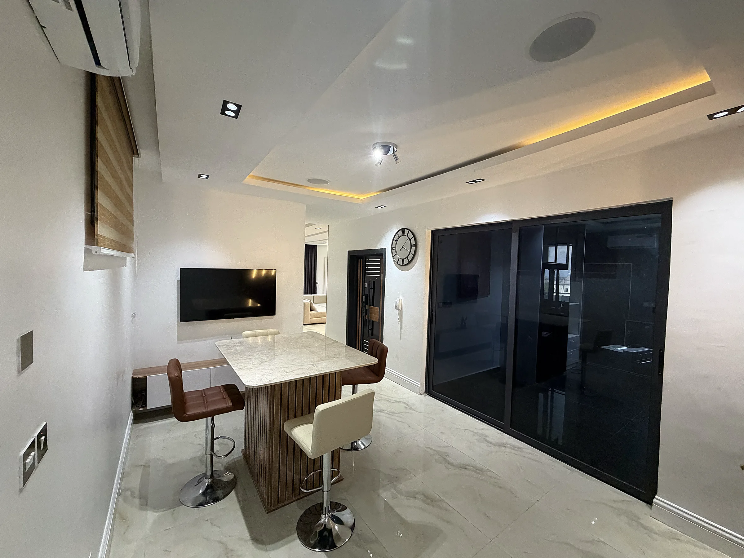 Breakfast area beside the kitchen with bar seating and warm display lighting
