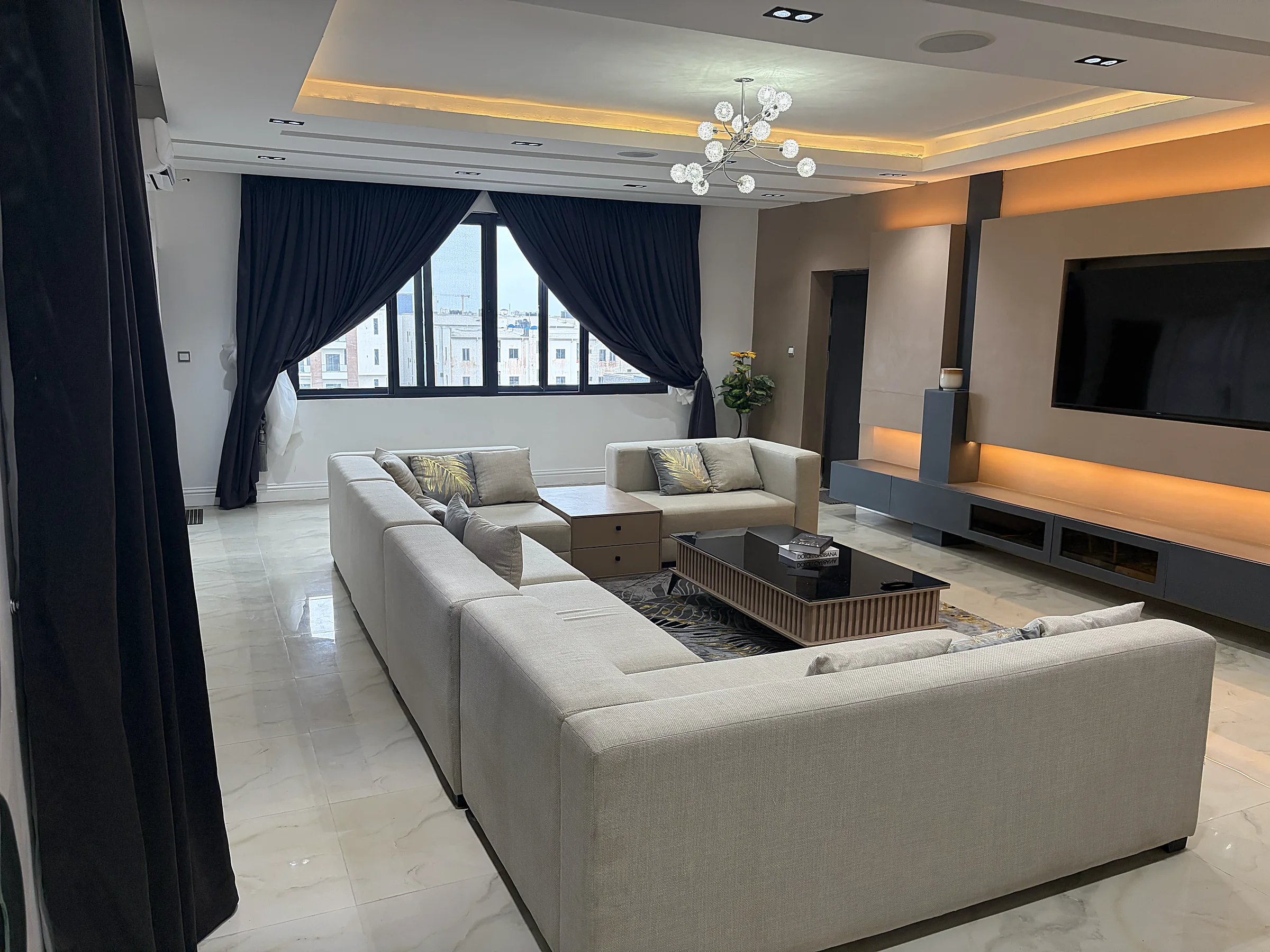 Canary Penthouse living room with wraparound seating and warm architectural lighting